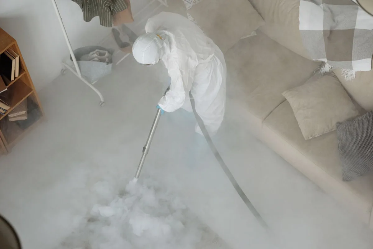 Biohazard cleanup technician in protective equipment, Woodmere, LA